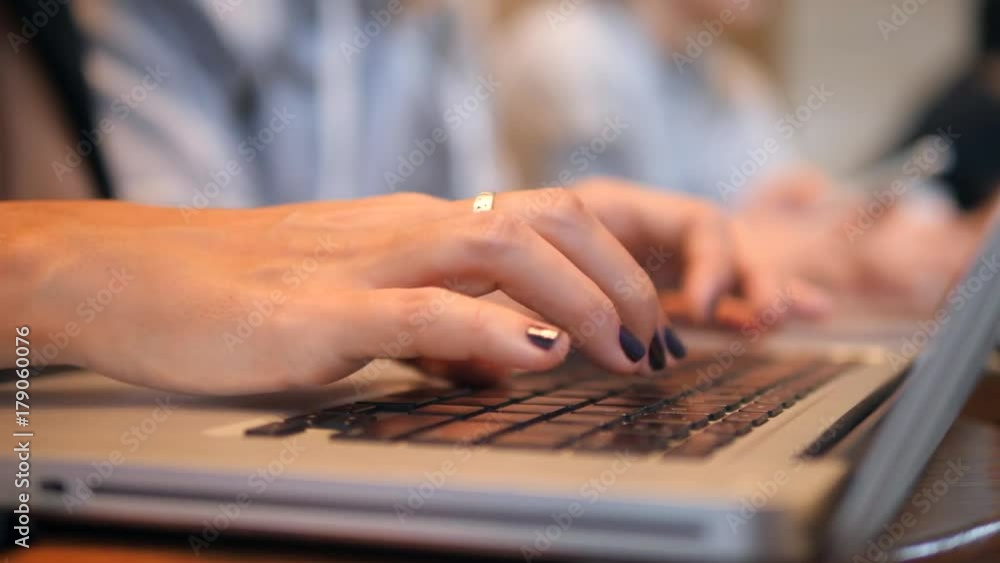 Woman's Hands Pressing Keys on a Laptop Keyboard. Young People Working on Computers in Co-Working Office. 4K, Close up. Woman's Hands Pressing Keys on a Laptop Keyboard. Young People Working on Computers in Co-Working Office. 4K, Close up.