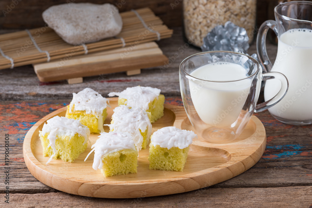 Coconut cake on wooden plate.