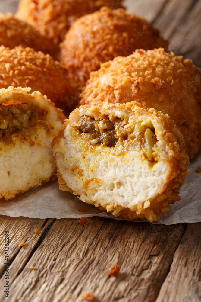 Japanese buns Kare-pan in breadcrumbs macro. vertical Japanese buns Kare-pan in breadcrumbs macro. vertical