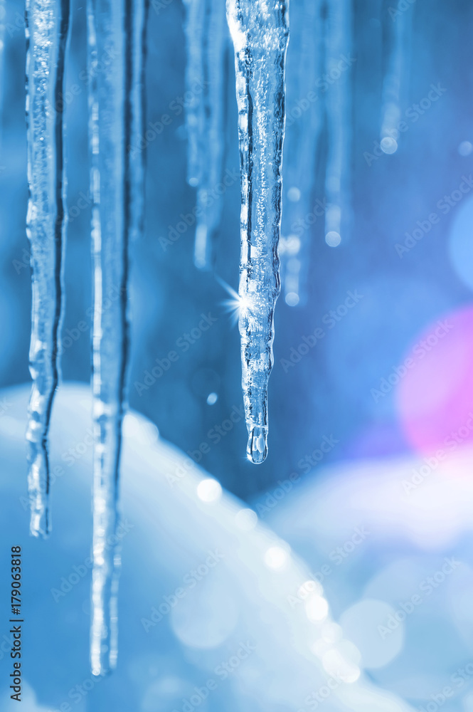 Background of bright transparent icicles in the sunlight Background of bright transparent icicles in the sunlight