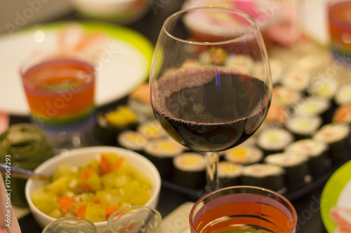 sushi colorful mix served dinner with wine, glasses, on table at restaurant, evening date, food photography