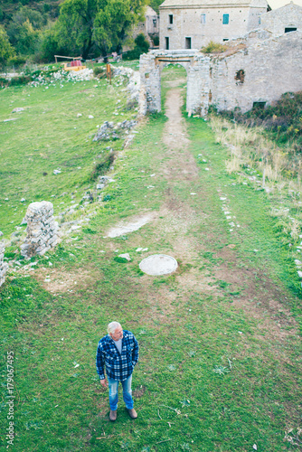 High angle view of man standing in town of Old Perithia. Corfu, Greece.