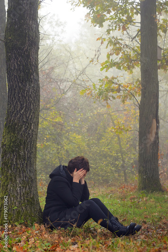 woman in depression in forest