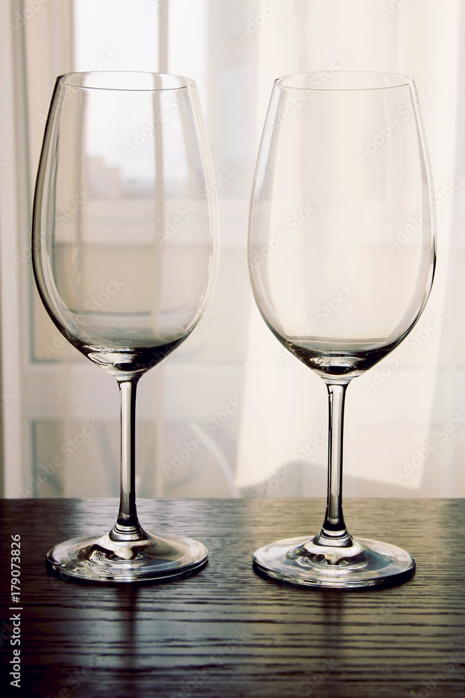 Two empty wine glasses on wooden table close up Two empty wine glasses on wooden table close up