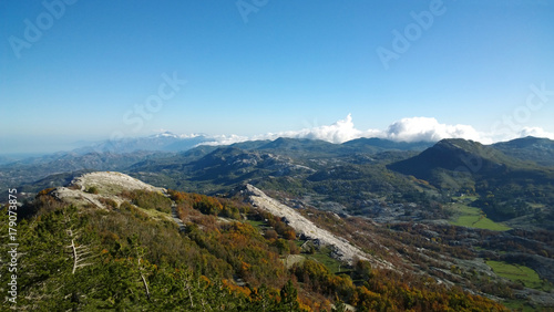 Panoramic view of autumn mountains Lovcen in Montenegro. Views of the peaks of the hills, the colorful trees and stones © kroshanosha