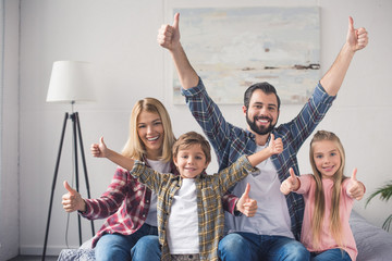 family showing thumbs up