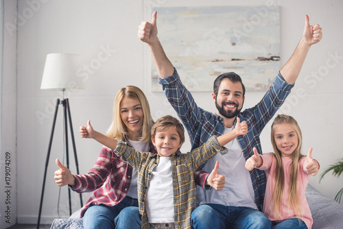 family showing thumbs up