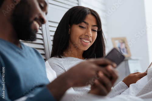 Cheerful happy couple looking at the smart phone