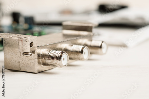 Fotografie Tv cable splitter on a white table in repair shop, macro shot