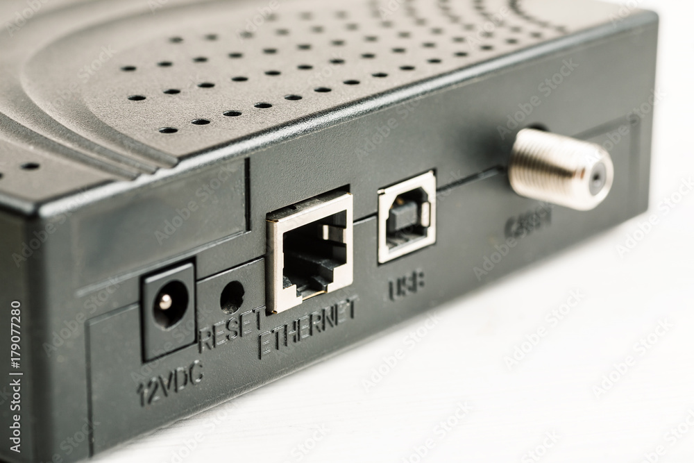 Old black ADSL router on a white table