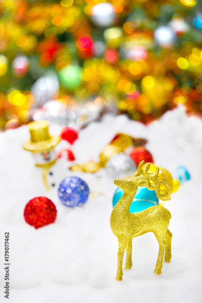 Deer and Christmas decoration in snow on glittery background