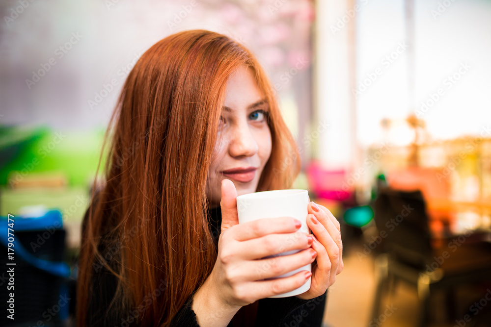 Beautiful girl drinking coffee at the coffee shop Beautiful girl drinking coffee at the coffee shop