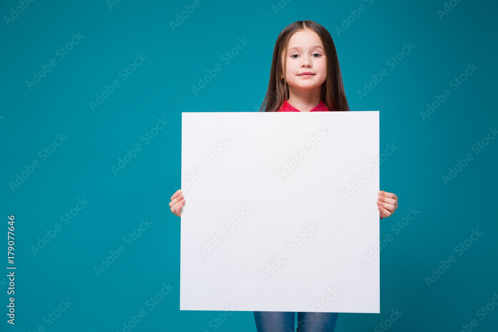 Cute little girl in checkered shirt with brunet hair hold clear paper Cute little girl in checkered shirt with brunet hair hold clear paper