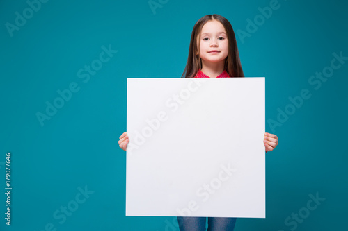 Photos Cute little girl in checkered shirt with brunet hair hold clear paper