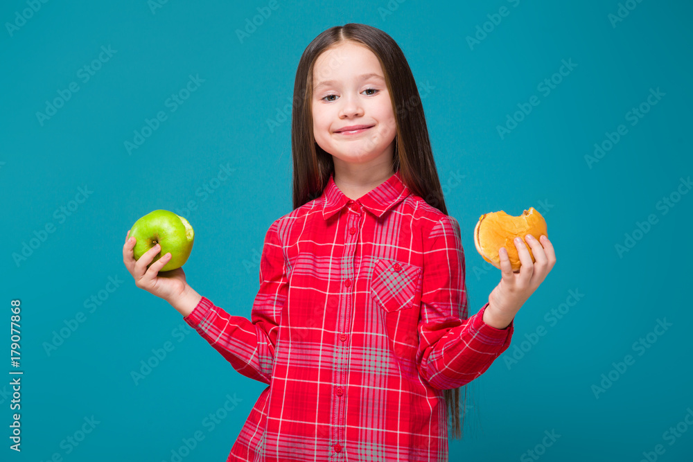 Pretty, little girl in checkered shirt with brunet hair hold burger Pretty, little girl in checkered shirt with brunet hair hold burger