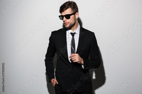 Portrait of a stylish confident man in suit and tie