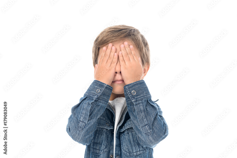 little boy covering eyes with hands