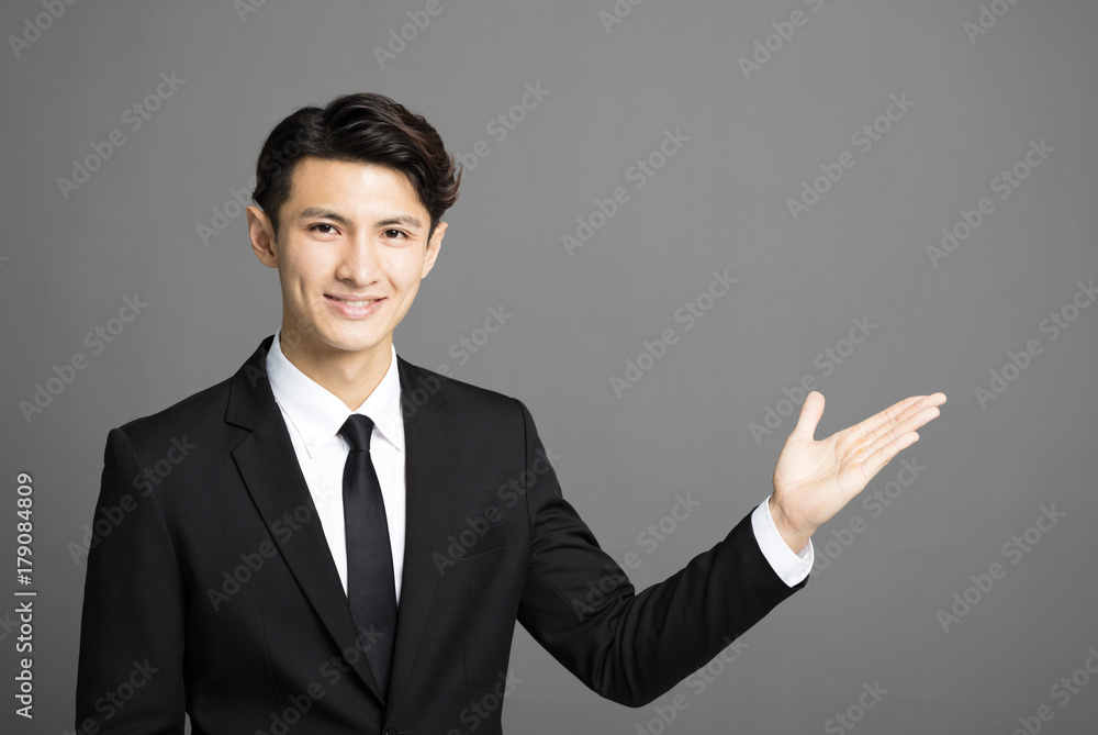 young smiling businessman introducing something young smiling businessman introducing something