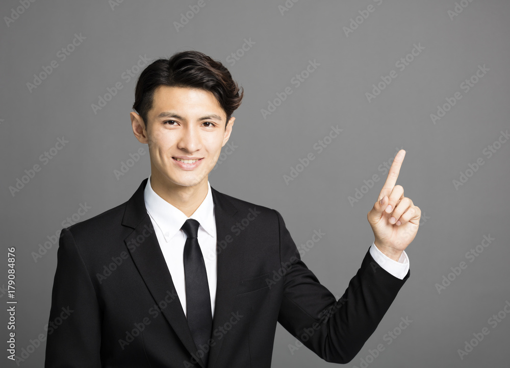 young smiling businessman with gray background young smiling businessman with gray background