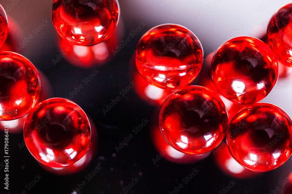 red capsules on mirror background red capsules on mirror background