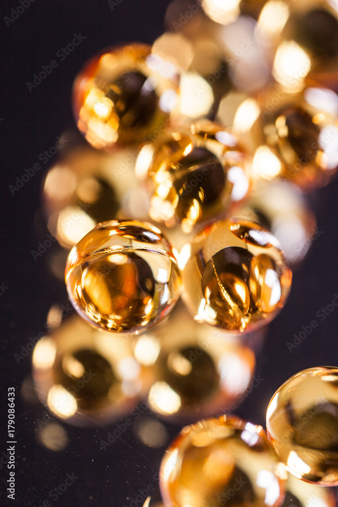 orange capsules on mirror background orange capsules on mirror background