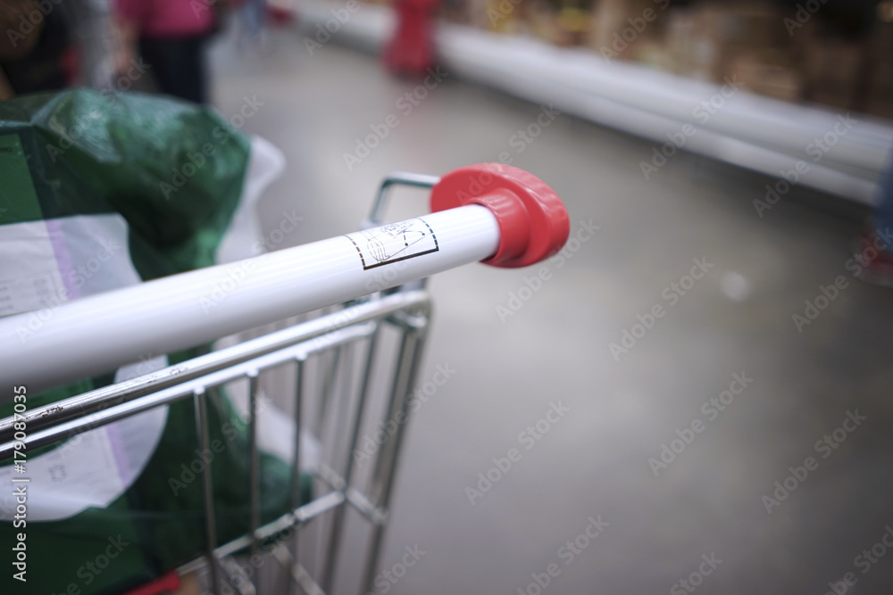 Close-up. Shop trolley with products. Blurred background of the store