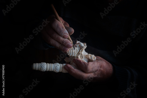 Craftsman hand works to create Tobacco pipe from meerschaum photo