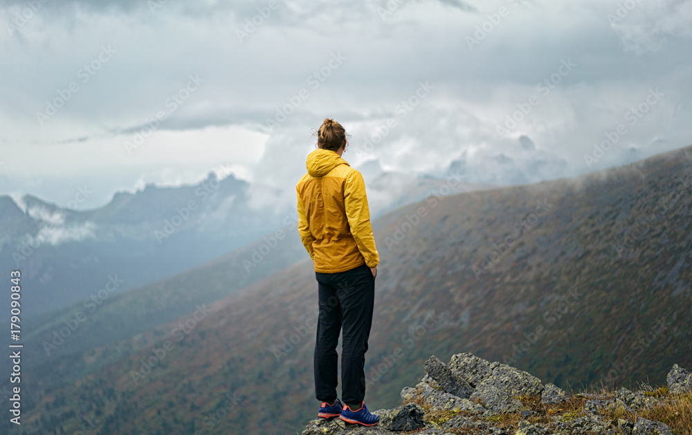 Man stands on the hill in the rain