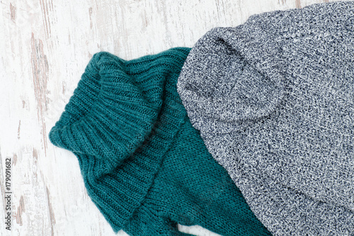 Two warm sweater with neck. Green and gray. Close up