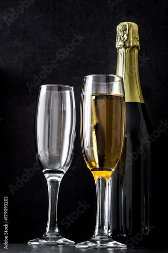 Champagne bottle and glasses on black background

