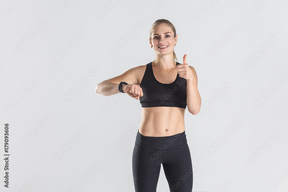 Energy woman, showing thumbs up at camera. Studio shot Energy woman, showing thumbs up at camera. Studio shot