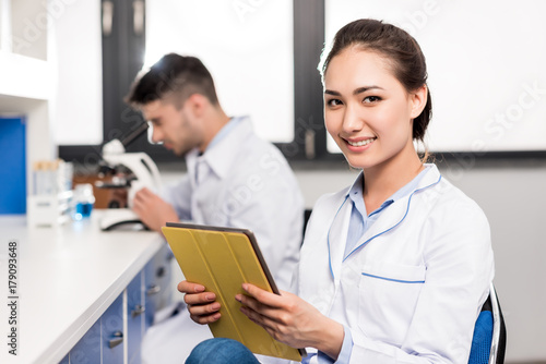 Wallpaper Mural smiling doctor with digital tablet Torontodigital.ca