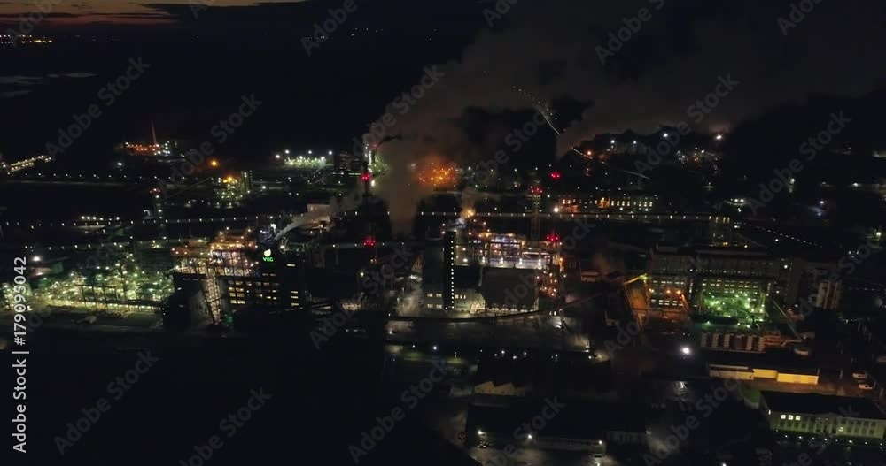 Night aerial shot of the oil refinery. Lots of lights. Industrial areal. Night aerial shot of the oil refinery. Lots of lights. Industrial areal.
