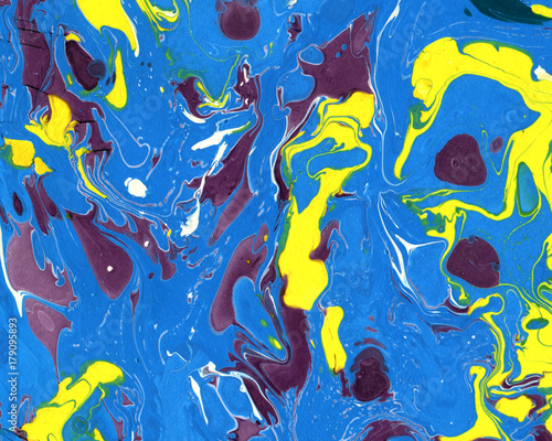 Abstract marbling ebru colorful background with blue  purple yellow blots  waves and splashes  handmade illustration. Beautiful brightly colored handmade background with marbling effect