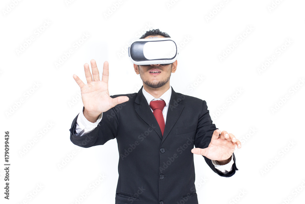 Businessman with glasses of virtual reality. Young guy in VR headset is looking at interactive screen. Playing mobile game app on device. Businessman with glasses of virtual reality. Young guy in VR headset is looking at interactive screen. Playing mobile game app on device.