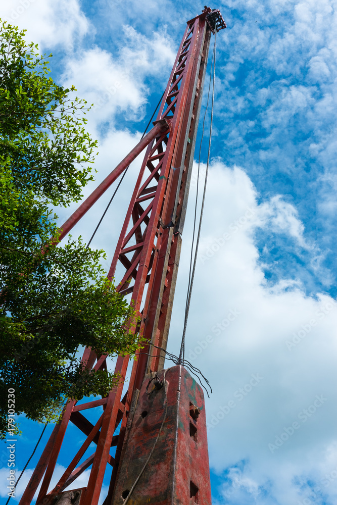 Pile driving crane doing lifting operation of piling rod at construction site Pile driving crane doing lifting operation of piling rod at construction site