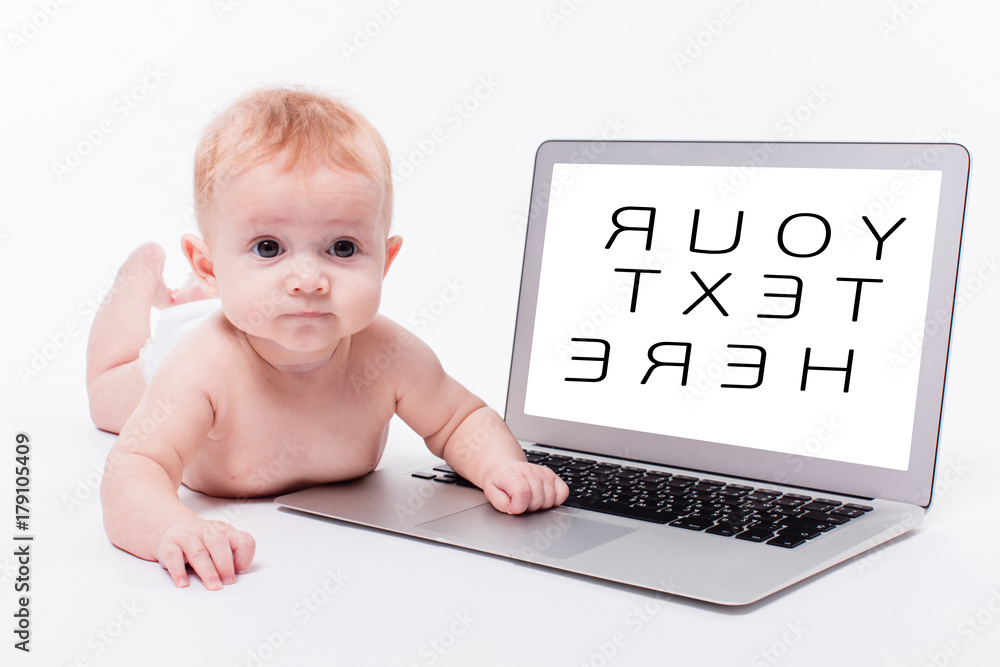 a beautiful little baby girl lying naked on her stomach on a white background in front of a laptop and learns to type on it a beautiful little baby girl lying naked on her stomach on a white background in front of a laptop and learns to type on it