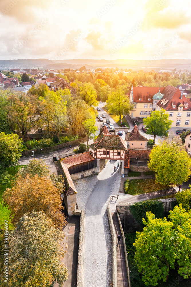 Europe culture concept - panoramic city skyline birds eye aerial view under dramatic sun and morning blue cloudy sky in Rothenburg, Germany