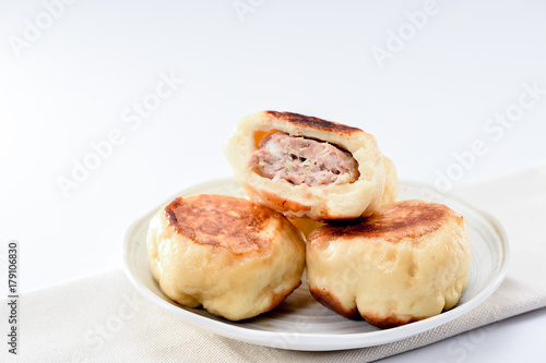 chinese traditional food pan-fried bun in white plate isolated onwhite background