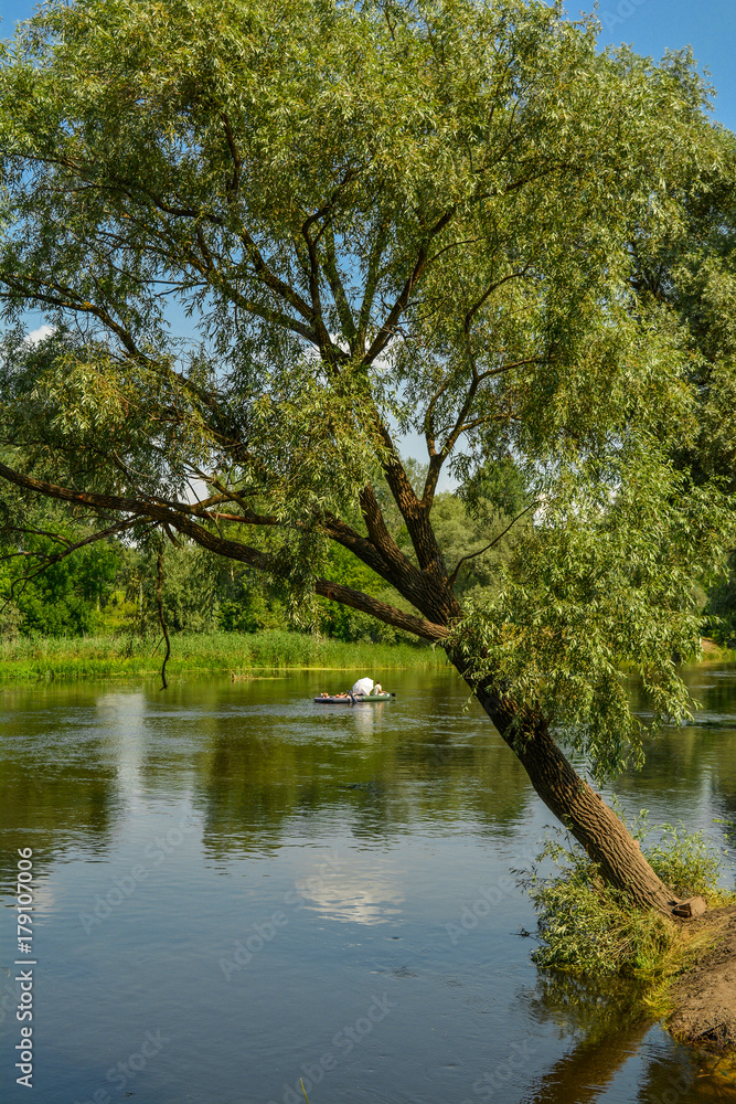 Tourists float on a raft down the river - a summer holiday. Tourists on the Seversky Donets River, Ukraine - summer landscape.