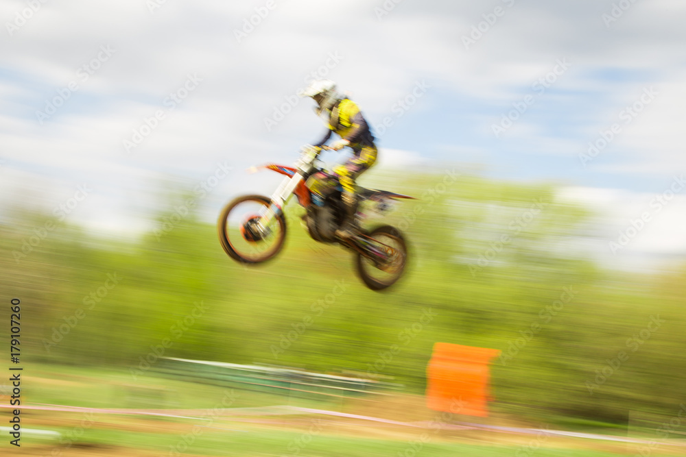 Fototapeta premium Biker on motocross jump in motion
