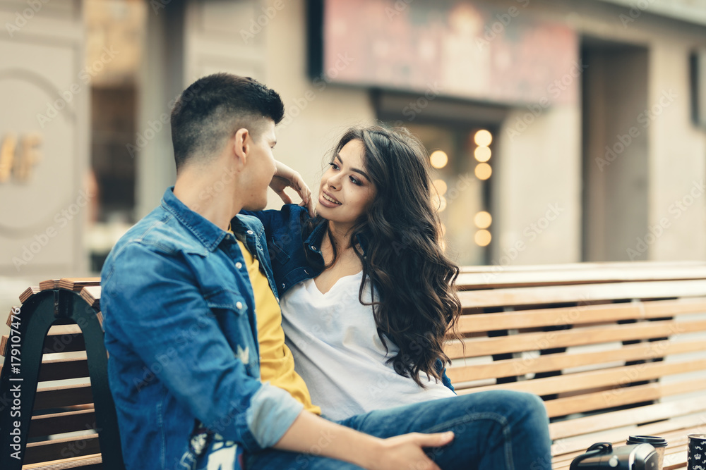 Romantic young couple having fun in the city spending time together. Smiling couple in love drinking coffee on the street.Excited happy couple full of affection and romance, hugging on the city street Romantic young couple having fun in the city spending time together. Smiling couple in love drinking coffee on the street.Excited happy couple full of affection and romance, hugging on the city street