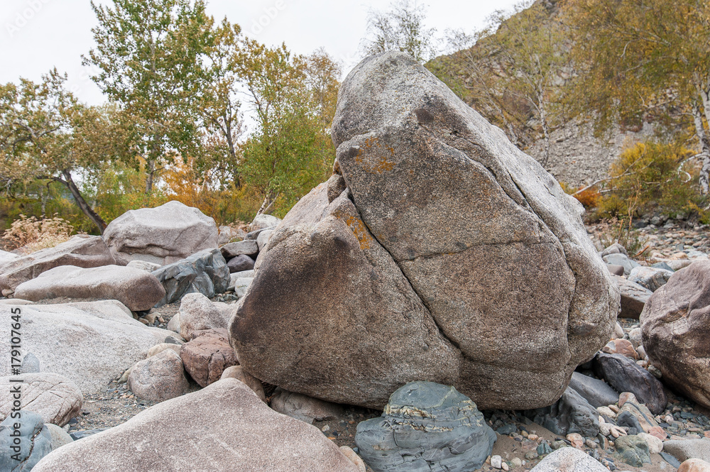 the boulder on the shore of the turquoise river the boulder on the shore of the turquoise river