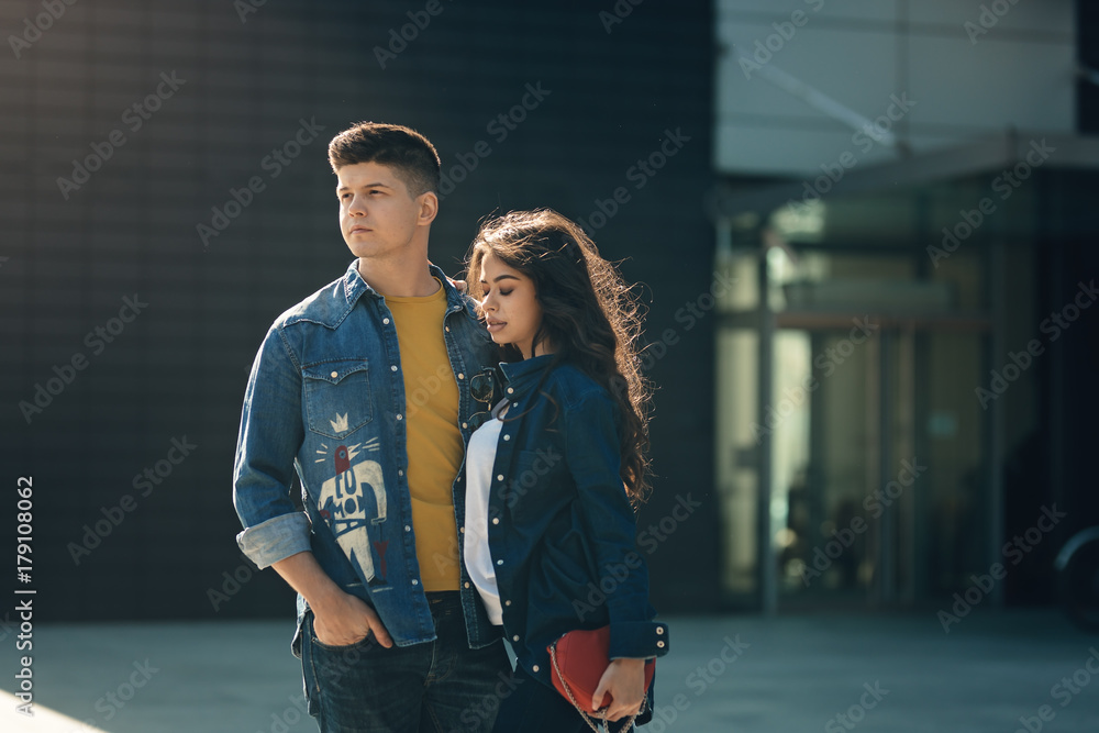 relationship goals couple holding hands and smiling in the beautiful city  full of romance joy and fun. Happy two girlfriend and boyfriend wearing  hipster fashion jacket walking and talking romantic Stock Photo