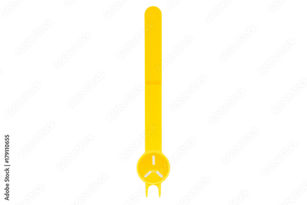 Close up unusual yellow plastic spoon isolated Close up unusual yellow plastic spoon isolated