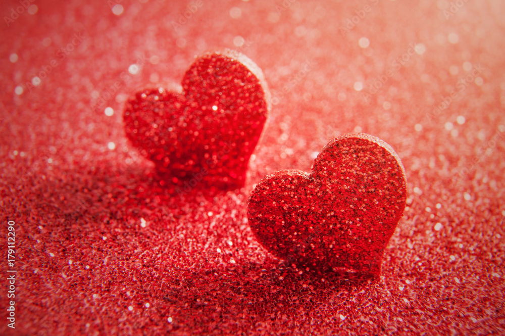 Valentines day bright red heart on a red glitter background. Artistic macro photo