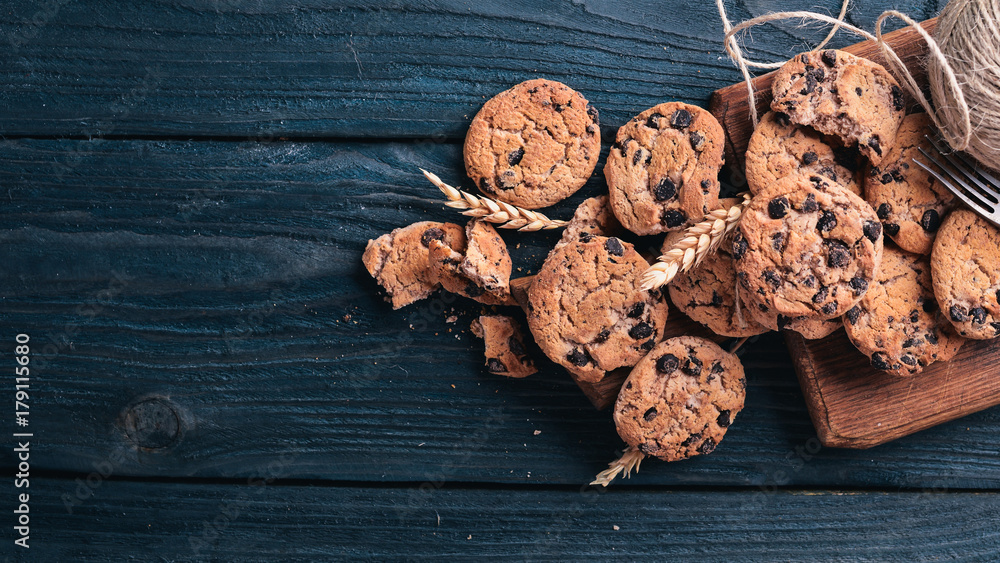 Cookies with chocolate. On a wooden background. Top view. Free space for your text. Cookies with chocolate. On a wooden background. Top view. Free space for your text.
