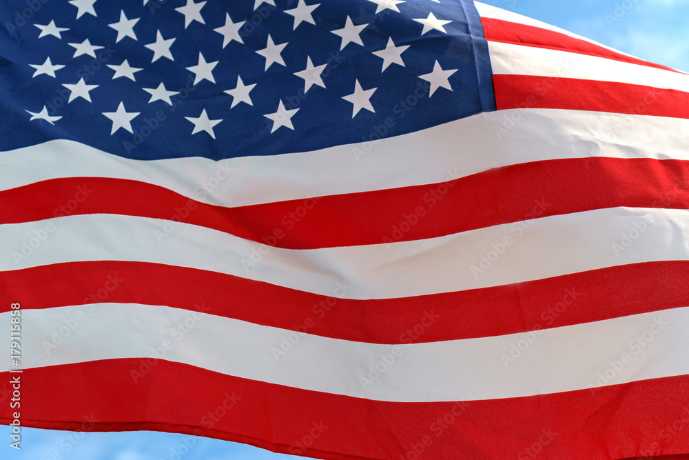 Obraz premium Waving star and stripes American flag on white background