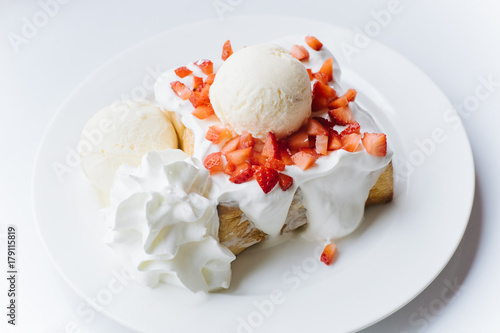 Strawberry Cream Toast on the white plate and white table.