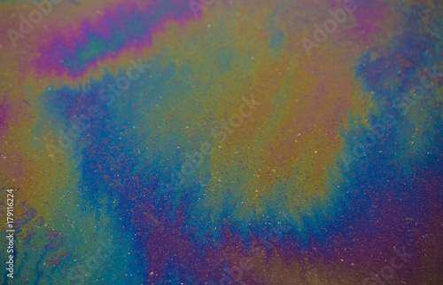 Abstract colours.Background texture of an oil spill on asphalt road